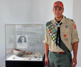 Boy Scout Troop 227&rsquo;s newest Eagle Scout, Ricardo 'Danny' Nieves, stands in front of the display case he put together for his project.